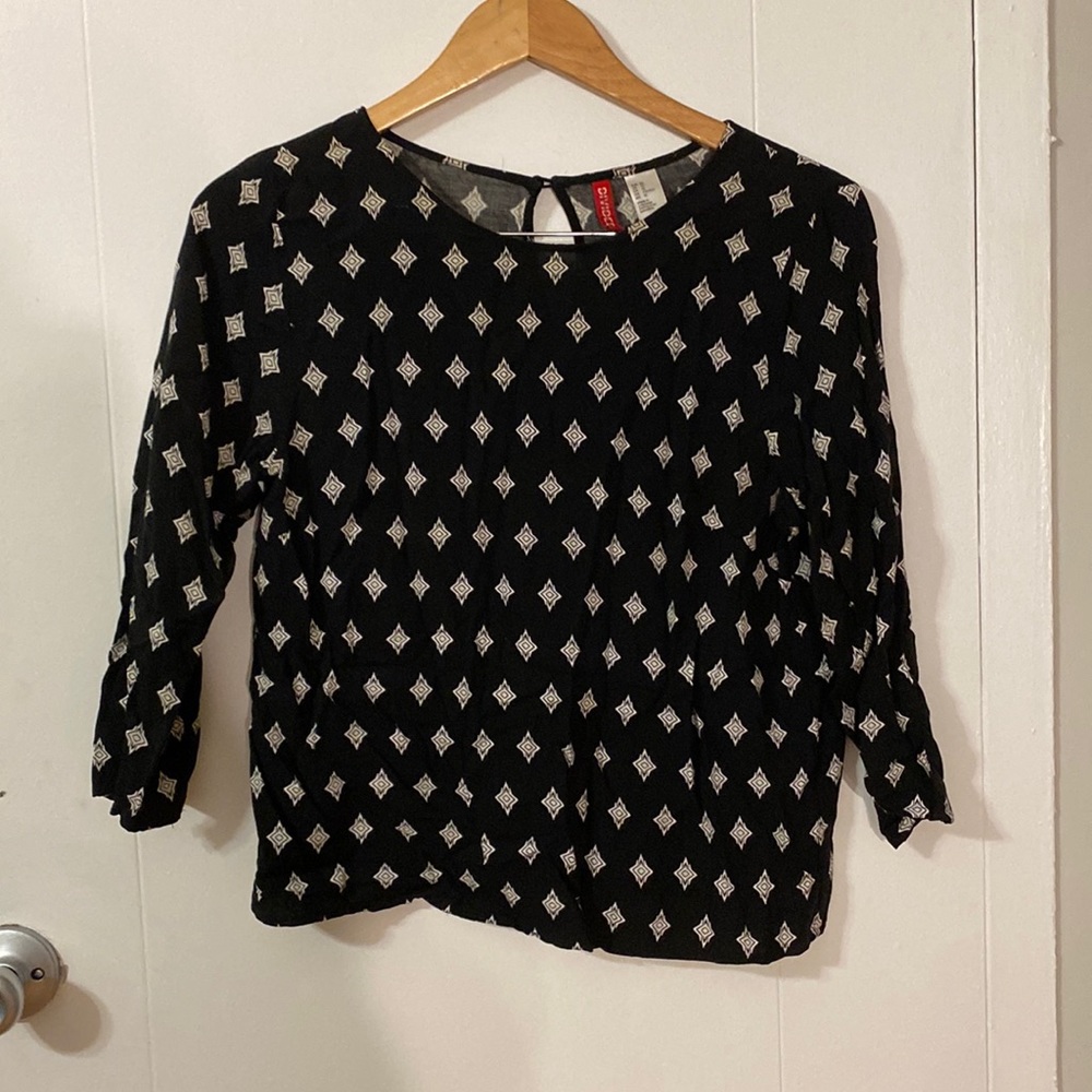 Black patterned shift cropped top with artful back buttons